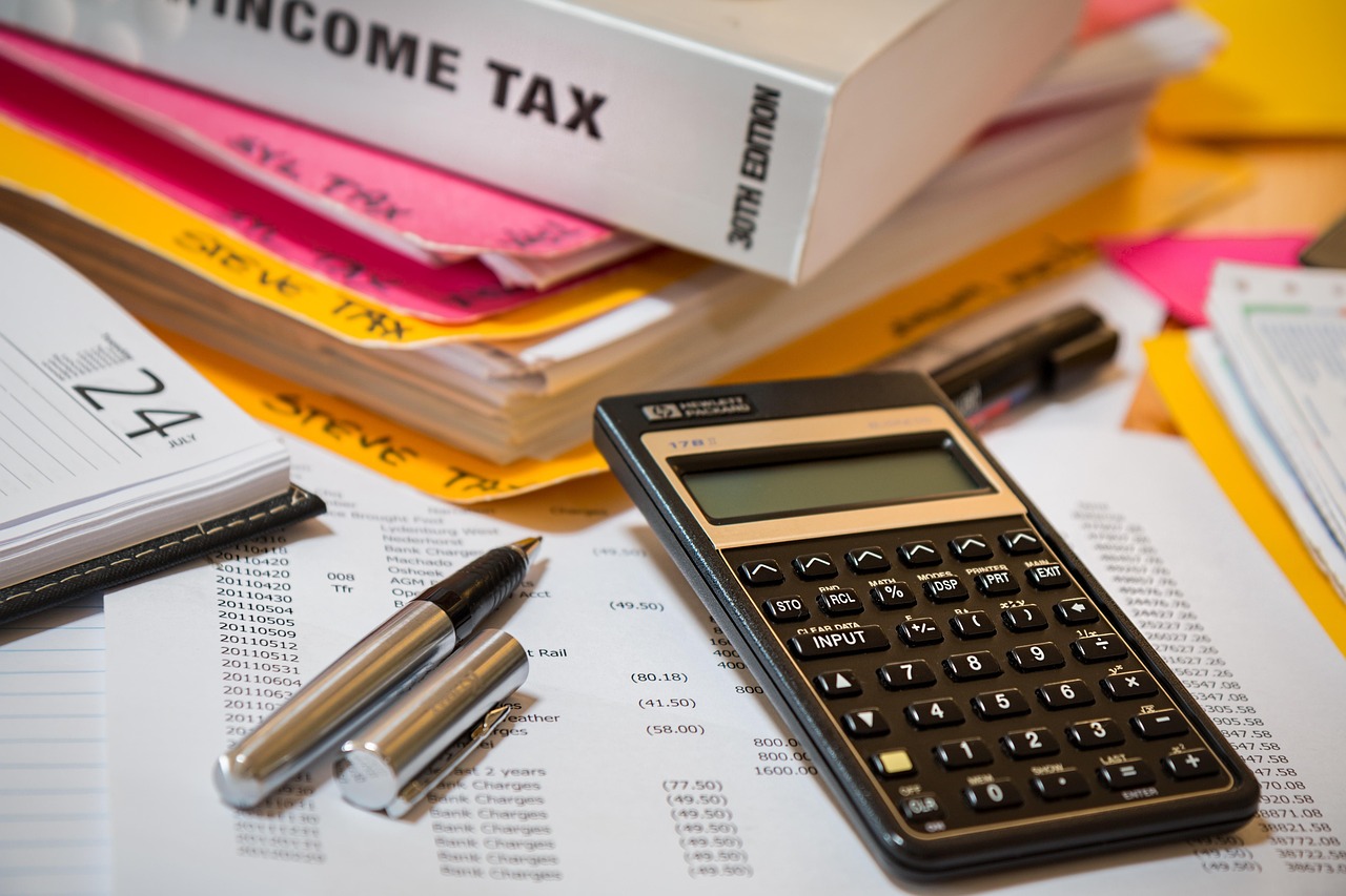 Income tax forms and a calculator on a desk