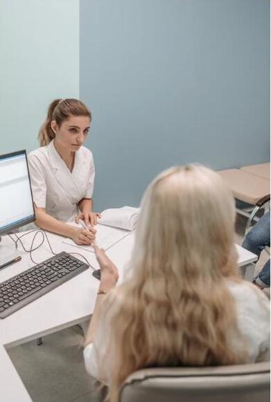 A healthcare provider consulting with a patient at a desk