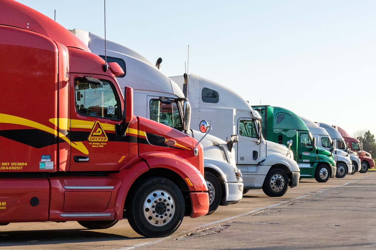 Row of semi trucks parked at a freight terminal