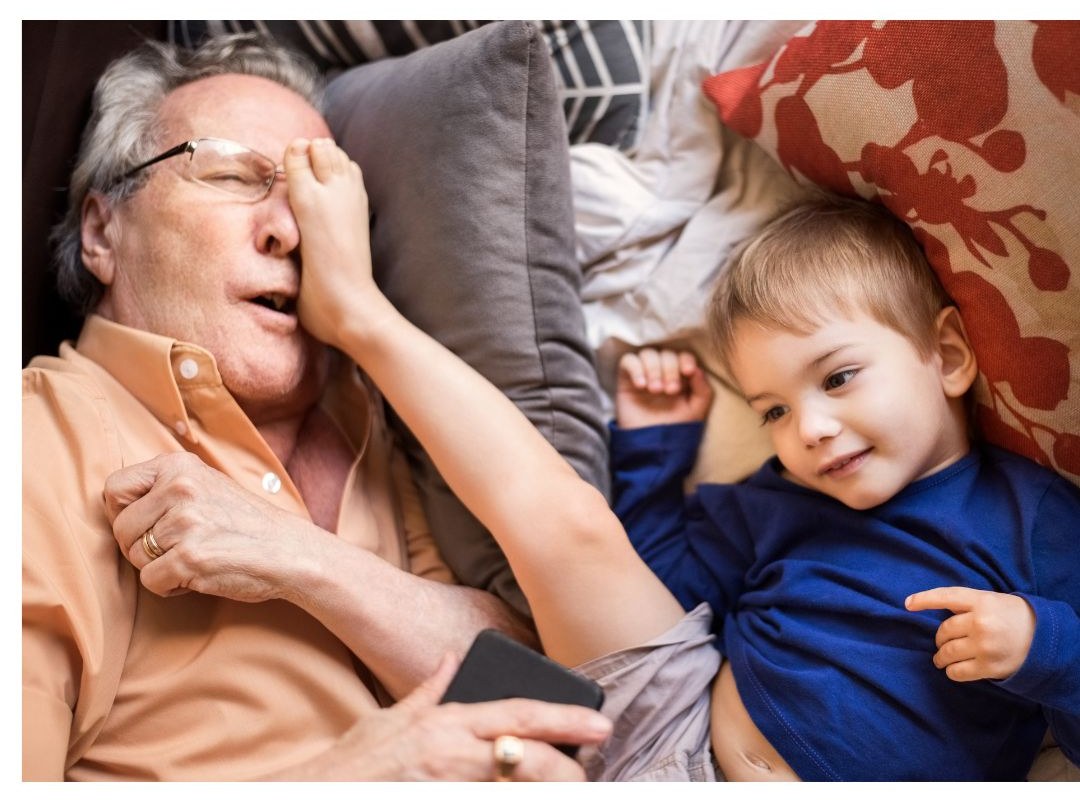 Grandfather laughing with his grandson at home