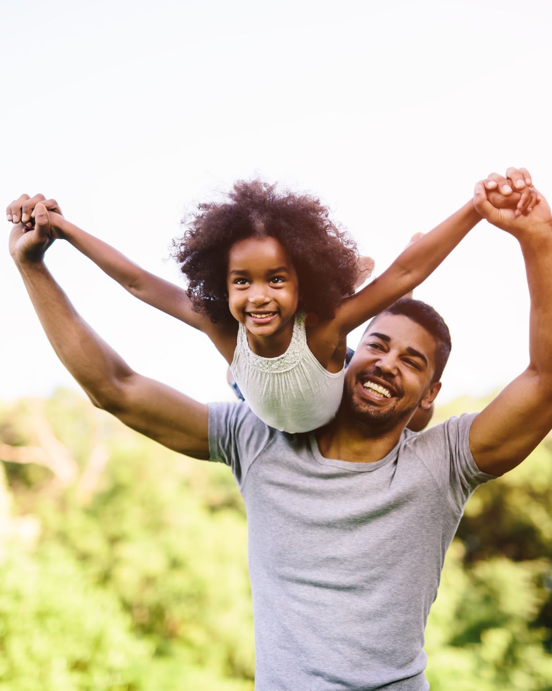 Father and daughter laughing together — the people we help protect